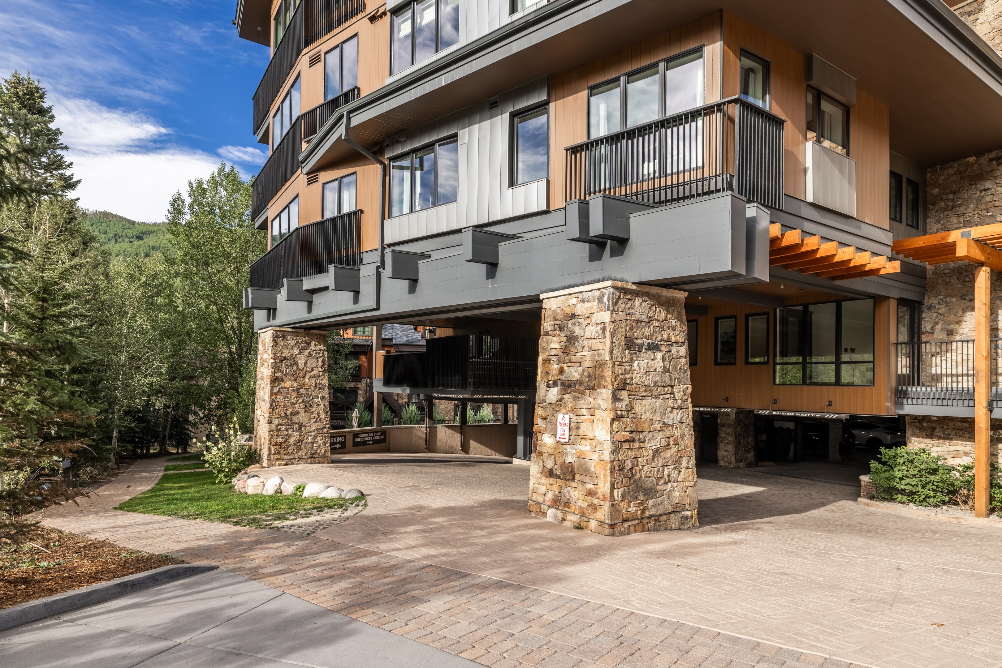 Entrance to under ground garage at Altus Vail and path to Gore Creek Trail.